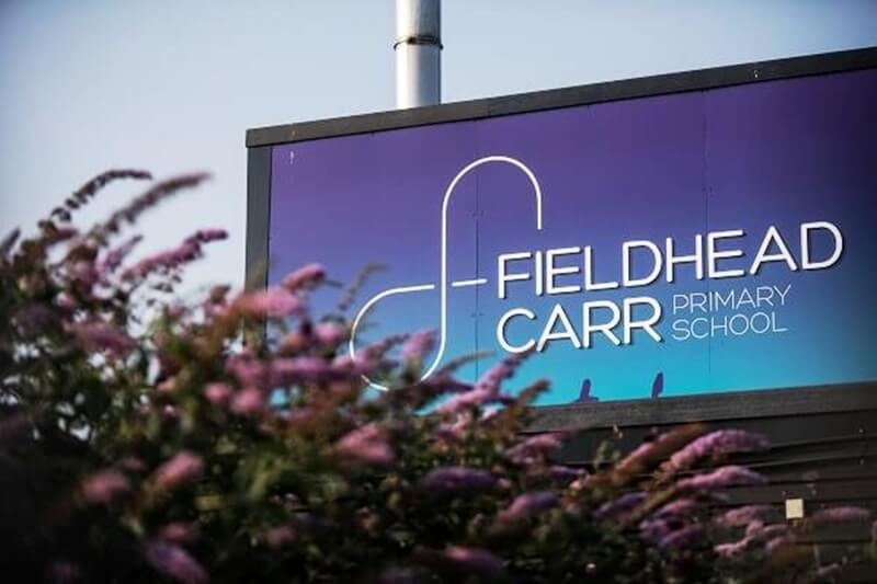 An image of the FieldHead Carr Primary School signage.